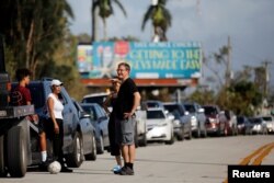 Local residents wait for the reopening of the entry road for the Florida Keys road after Hurricane Irma strikes Florida, in Homestead, Florida, Sept. 11, 2017.