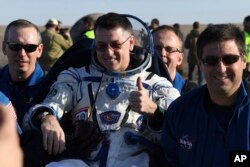 Ground personnel carry US astronaut Robert Shane Kimbrough shortly after Russia's Soyuz MS-02 space capsule carrying three members of the ISS landed near Dzhezkazgan, Kazakhstan, April 10, 2017.
