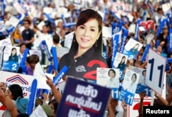 FILE - Supporters of Palang Pracharath Party attend their last party campaign rally outside a stadium in central Bangkok, Thailand, March 22, 2019.