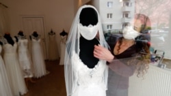 Fashion designer and tailor Friederike Jorzig presents a face mask for wedding dresses in her shop 'Chiton', as the spread of the coronavirus disease (COVID-19) continues in Berlin, Germany, March 31, 2020. REUTERS/Fabrizio Bensch