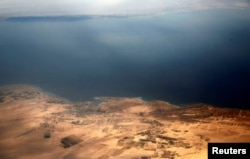 An aerial view of the coast of the Red Sea and the two islands of Tiran and Sanafir is seen through the window of an airplane near Sharm el-Sheikh, Egypt, Nov. 1, 2016.