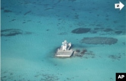 FILE - Photo taken by surveillance plane,shows Chinese-made structures on the Johnson Reef, called Mabini by the Philippines and Chigua by China.