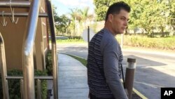FILE - Luis Alberto Rodriguez, 43, waits for a friend to pick him up from temporary housing in Miami, Jan. 13, 2017.
