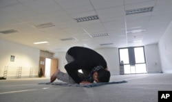 FILE - In this July 13, 2015, photo, Minhaj Uddin Syed prays at a temporary musalla (prayer room) set up for the holy month of Ramadan in the central business district of Sydney, Australia.