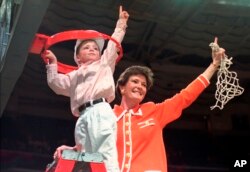 FILE - Tennessee coach Pat Summitt and son, Tyler, take down the net after Tennessee defeated Georgia, 83-65, in the title game at the NCAA women's basketball Final Four at Charlotte Coliseum in Charlotte, North Carolina, March 31, 1996.