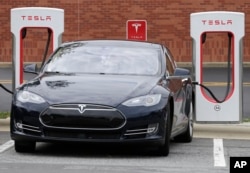 A Telsa car recharges at a Tesla charging station in Charlotte, North Carolina, June 24, 2017.