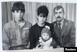 Pictured is Tamerlan (C) Tsarnaev, accompanied by his father Anzor (L), mother Zubeidat and uncle Muhamad Suleimanov (R), in this photo courtesy of the Suleimanova family.