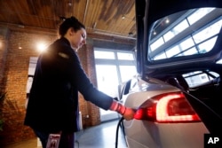 FILE - An electric car is seen at a dealership in Seattle, Feb. 4, 2015.