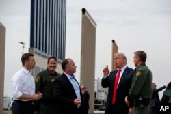 FILE - President Donald Trump reviews border wall prototypes in San Diego, March 13, 2018.