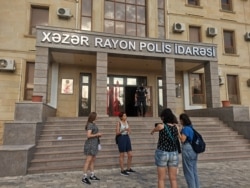 Azerbaijani women's rights activists threw red paint on the door of the local police station in protest to the authorities' inaction in response to complaints about domestic violence, Baku, Azerbaijan, Aug. 4, 2021. (Ulviyya Guliyeva/VOA)