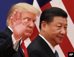 Chinese President Xi Jinping walks with U.S. President Donald Trump, Nov. 9, 2018, after attending a business event at the Great Hall of the People in Beijing.
