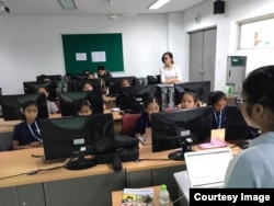 The “Cambodia Identity Product” girls team listen to Tes Putthira, a technical mentor for coding during a 12-weekend training at the Cambodia-Korea Cooperation Center. (Courtesy of Technovation Cambodia)