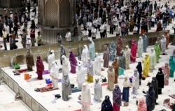 Indonesian Muslims pray spaced apart as they practice social distancing to curb the spread of the new coronavirus during an evening prayer at Istiqlal Mosque in Jakarta, Indonesia. Monday, April 12, 2021. (AP Photo/ Achmad Ibrahim)