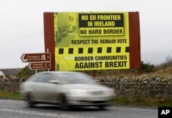FILE - A car crosses over the border from the Irish Republic into Northern Ireland near the town of Jonesborough, Northern Ireland, Jan. 30, 2017.