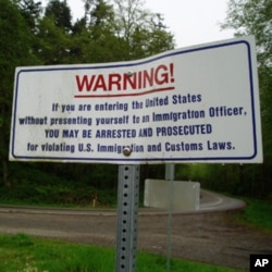Warning signs like this one are posted along the US-Canada border.
