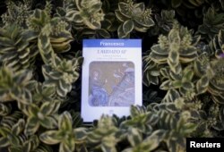 FILE - Pope Francis' encyclical titled "Laudato Si (Be Praised), On the Care of Our Common Home" is displayed during the presentation news conference at the Vatican, June 18, 2015.