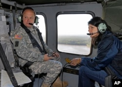 South Carolina Gov. Nikki Haley, right, and Major Gen. Bob Livingston, left, view flood damage from a helicopter in Columbia, S.C., Oct. 6, 2015.