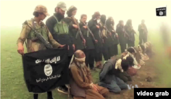 FILE - An image from a purported Islamic State group video showing captives. The recent beheadings of members of the minority Shi’ite Hazara ethnic community sparked protests in Kabul.