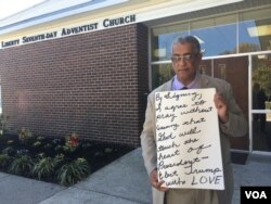 Rocky Twyman solicits signatures on a card that reads: "By signing, I agree to pray without ceasing that God will touch the heart of President-elect Trump with LOVE," at Liberty Seventh-day Adventist Church in Baltimore, Maryland. (A. Arabasadi/VOA)