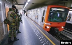 FILE - Belgian soldiers patrol in a subway station in Brussels, Nov. 25, 2015. Brussels' metro re-opened on Wednesday after staying closed for four days following tight security measures linked to the fatal attacks in Paris.