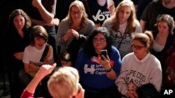 The crowd listens as Sen. Elizabeth Warren, D-Mass, speaks during an organizing event at Curate event space in Des Moines, Iowa, Jan. 5, 2019.
