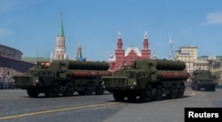 FILE - Russian servicemen drive S-400 missile air defense systems during the Victory Day parade in Moscow, May 9, 2018.