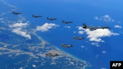 This handout photo taken Sept. 18, 2017, and provided by the South Korean Defense Ministry in Seoul shows U.S. and South Korean fighter jets flying over South Korea during a joint military drill aimed to counter North Korea’s latest nuclear and missile test.