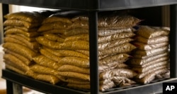 FILE - Bags of sample yellow soybeans are stored at Deerfield Farms Service on April 5, 2018, at the facility in Volant, Pa. After the Trump administration unveiled plans to impose tariffs on Chinese imports, China struck back.