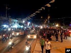 Followers of Shii'te cleric Muqtada al-Sadr celebrate in Sadr City, Baghdad, Iraq, early Monday, May 14, 2018.