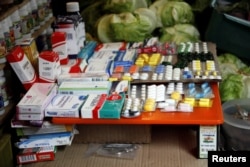 Medicines are displayed on sale in a fruit and vegetables stall at a market in Rubio, Venezuela, Dec. 5, 2017.