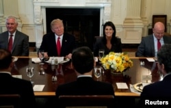 FILE - U.S. President Donald Trump, seated with then-Secretary of State Rex Tillerson, U.S. Ambassador to the United Nations Nikki Haley and then-U.S. National Security Adviser H.R. McMaster, hosts a lunch for ambassadors to the United Nations Security Council, at the White House in Washington, Jan. 29, 2018.