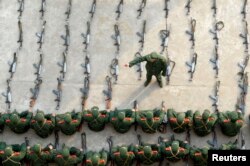 FILE - Paramilitary recruits listen to a briefing during a regular training session at an army base in Nanjing, east China's Jiangsu province.