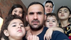 FILE - An Afghan refugee family poses in Toronto, Aug. 17, 2021,