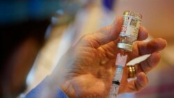 FILE: A Chester County, Pa., Health Department worker fills a syringe with Moderna COVID-19 vaccine before administering it at the Chester County Government Services Center in West Chester, Pa, Dec. 29, 2020.