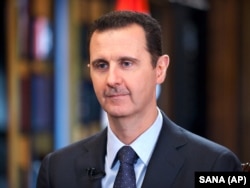 Syrian President Bashar Assad speaks during an interview with Venezuela's state-run Telesur network, in Damascus, Syria, 25 Sept. 2015.