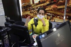 Diana Lopez presents a one-hour class through Bacata Stereo radio station in Funza, Colombia, Wednesday, May 13, 2020.