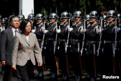 Taiwanese President Tsai Ing-wen inspects honour guard before a ceremony to mark the 92nd anniversary of the Whampoa Military Academy, in Kaohsiung, southern Taiwan, June 16, 2016.