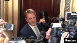 Republican Senator Jeff Flake reacts during a confrontation with a protester in an elevator in Washington, Sept. 28, 2018 in this still image obtained from a social media video.