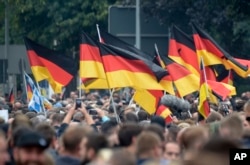 Demonstrators carry German flags during a rally in Chemnitz, eastern Germany, Sept. 1, 2018.