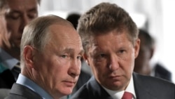 FILE - Russian President Vladimir Putin, left, and Alexei Miller, Russian natural gas giant Gazprom CEO, attend a meeting in Novobureyskiy, Russia, on Aug. 3, 2017.