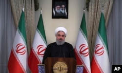 In this photo released by official website of the office of the Iranian Presidency, President Hassan Rouhani addresses the nation in a televised speech in Tehran, Iran, May 8, 2018.