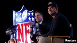 San Francisco 49ers head coach Jim Harbaugh (R) and his brother, Baltimore Ravens head coach John Harbaugh, speak during their joint press conference ahead of the NFL's Super Bowl XLVII in New Orleans, Louisiana, Feb. 1, 2013