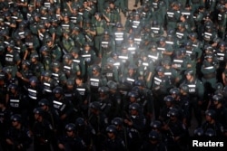 Cambodia's armed forces display anti-riot gear and assault rifles at the Olympic stadium ahead of a general election this weekend, in Phnom Penh, Cambodia, July 25, 2018.