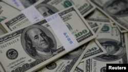 FILE - U.S. one-hundred dollar bills are shown.