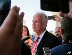 U.S. Sen. Jerry Moran, R-Kan., speaks to reporters following a town hall meeting, July 6, 2017, in Palco, Kan. Critics of GOP efforts to overhaul traveled to the tiny town in western Kansas to pressure Moran.
