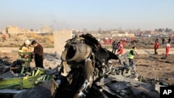 Debris is seen from an Ukrainian plane which crashed as authorities work at the scene in Shahedshahr, southwest of the capital Tehran, Iran, Jan. 8, 2020. 