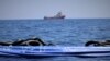 The migrant rescue ship Ocean Viking, run by two French charities, floats in the distance, as it waits in international waters between Malta and southern Italy for access to a port in this handout picture taken between Aug. 9 and 12, 2019.