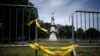 FILE - A statue of Christopher Columbus is seen behind barricades at Marconi Plaza, in Phalidelphia, Pennsylvania, June 15, 2020. A similar statue of Columbus was toppled by protesters in Baltimore, Maryland, July 4, 2020.