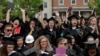 FILE - Graduating seniors react during Commencement ceremonies at Smith College in Northampton, Massachusetts, May 21, 2017