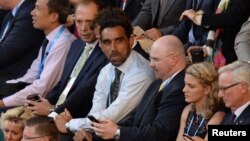 Australian of the Year 2014 Adam Goodes (C), attends the men's singles final match at the 2014 Australian Open tennis tournament in Melbourne on Jan. 26, 2014. 